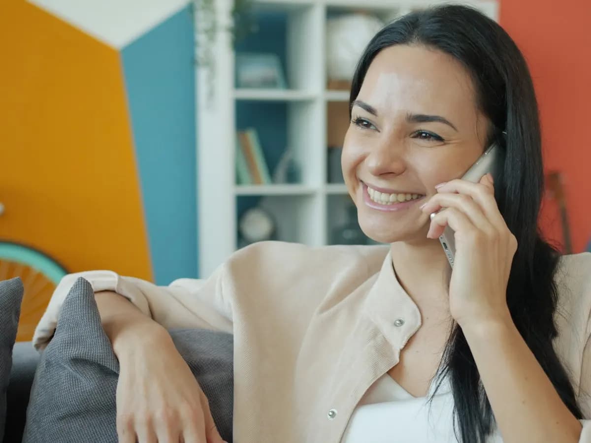 Smiling homeowner on a phone call with our support team