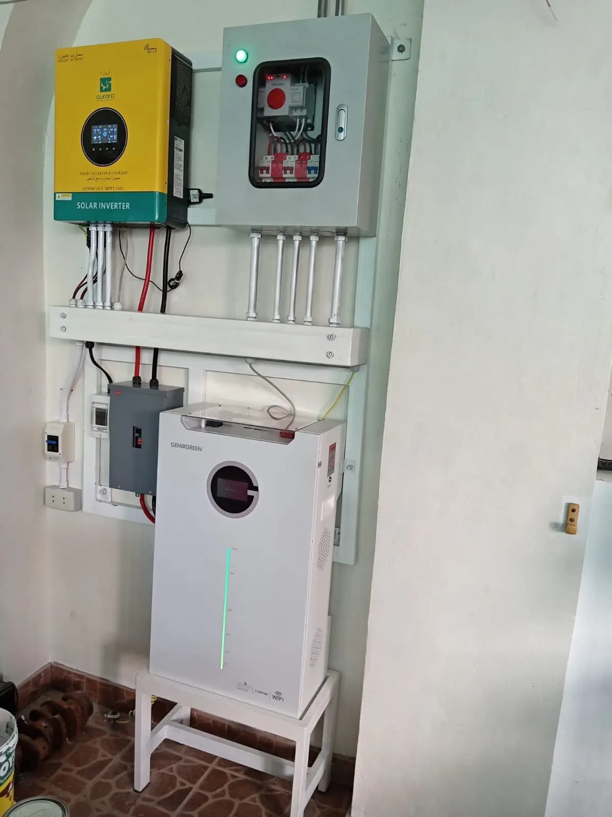 Hybrid inverter and protection box above a battery on a raised stand