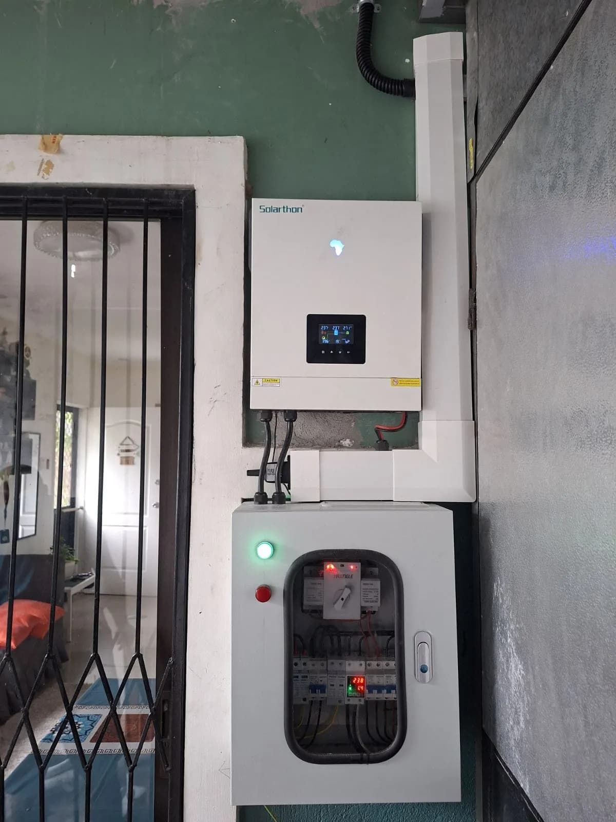 On-grid inverter mounted above a solar protection box